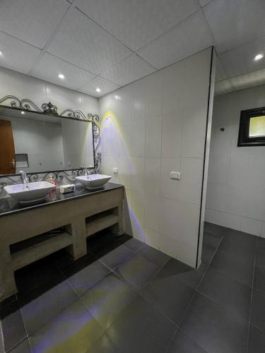 a bathroom with two sinks and a large mirror at American Villa Dahab in Dahab
