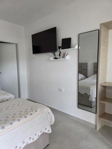 a bedroom with a mirror and a bed at Dream - sea view apartment in Pučišća
