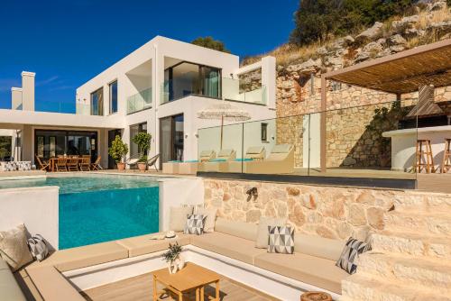 a villa with a swimming pool and a house at Kefalonia Grande Horizon in Ayia Evfimia
