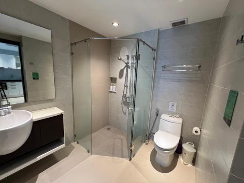 a bathroom with a shower and a toilet and a sink at Emerald Terrace Condo 42- 1 Bed Pool in Patong Beach