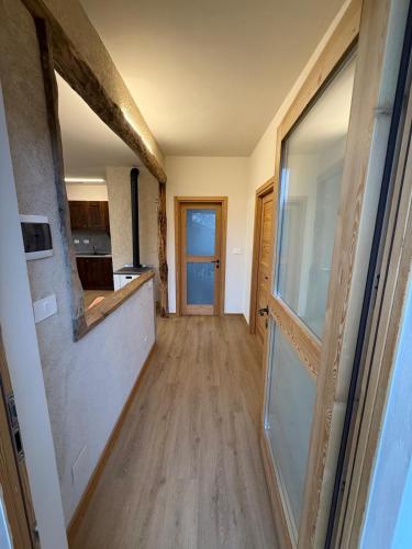 a hallway leading to a kitchen with a glass door at La Ca d'Marietta in Paesana