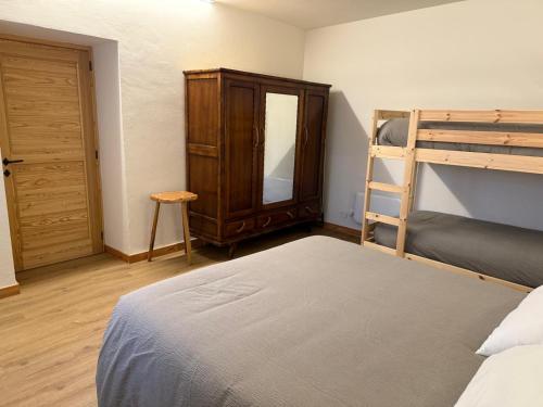 a bedroom with a bunk bed and a ladder at La Ca d'Marietta in Paesana