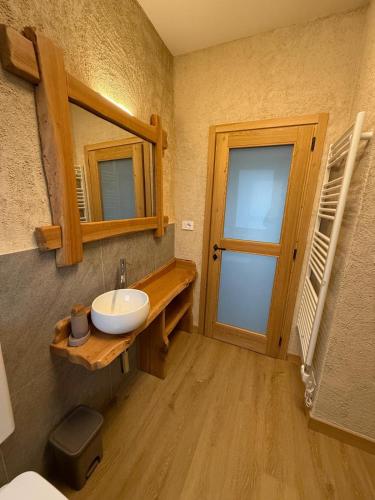 a bathroom with a sink and a mirror at La Ca d'Marietta in Paesana