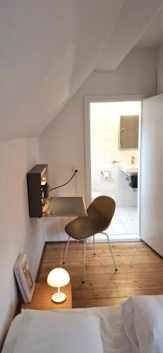 a bedroom with a bed and a desk and a bathroom at Villa Pineta in Fusio
