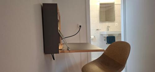 a bathroom with a sink and a mirror and a chair at Villa Pineta in Fusio