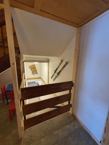 an attic room with a staircase and baseball bats at Burgbühler Guesthouse in Lenk
