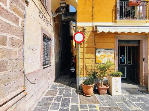 a street with a no entry sign next to a building at Sa Costa - Castleview Bosa in Bosa