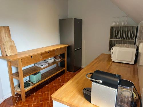 a kitchen with a refrigerator and a wooden counter at Casa das Flores Leiria Silvercoast Portugal in Monte Redondo