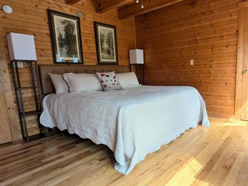 a bedroom with a bed in a wooden room at Garnerland in Luray with Hot Tub and Pet Friendly in Luray