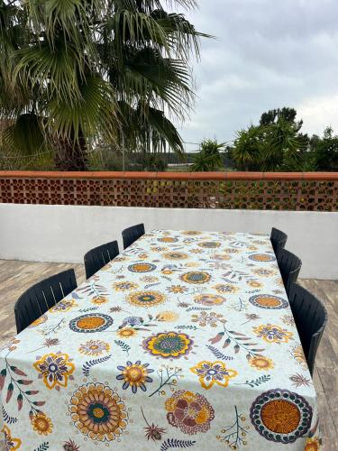 a table with a table cloth with flowers on it at Casa das Flores Leiria Silvercoast Portugal in Monte Redondo