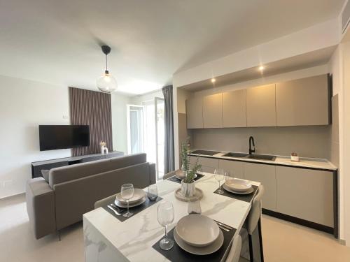 una cucina e un soggiorno con tavolo e sedie di La Perla del Mare ad Anzio