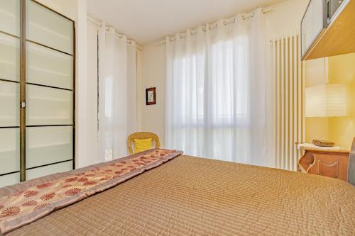 a bedroom with a large bed and a window at Carthusia View - Affitti Brevi Italia in Certosa di Pavia