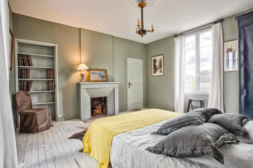 une chambre avec un lit et une cheminée dans l'établissement Villa 1880 - Centre Ville - Jardin Botanique, à Cabourg
