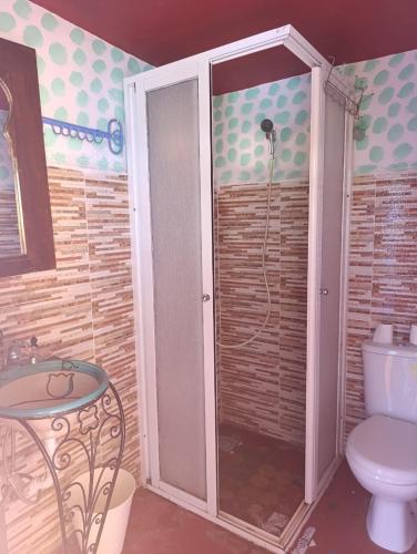 a bathroom with a shower with a toilet and a table at hotel dar lalla khadouj in Chefchaouene