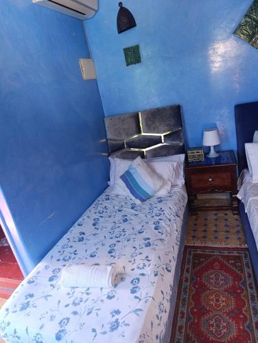 a bedroom with a bed with a dog laying on it at hotel dar lalla khadouj in Chefchaouene