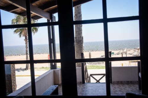 a view of the beach from a window at Complejo Costa Marina in Miramar