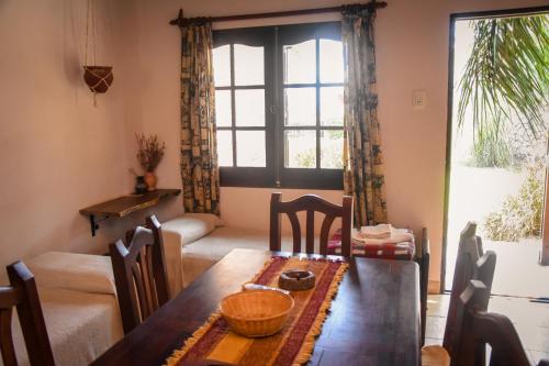a dining room with a table and chairs and a window at Complejo Costa Marina in Miramar