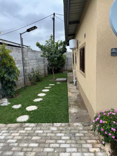a side walk next to a building with a yard at Silverest Place in Lusaka