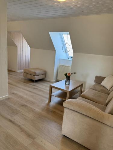 a living room with a couch and a table at Stor lejlighed tæt på Saltum in Brønderslev