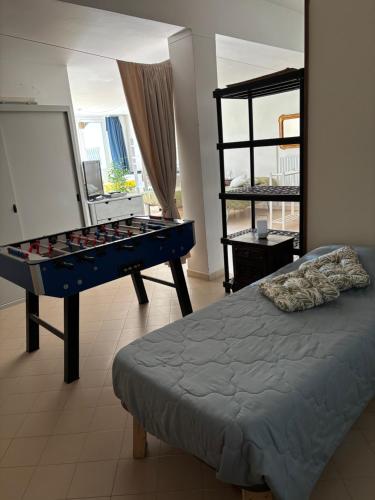 a bedroom with a bed and a table and a window at Paradise - nature and wellness in Pino Torinese