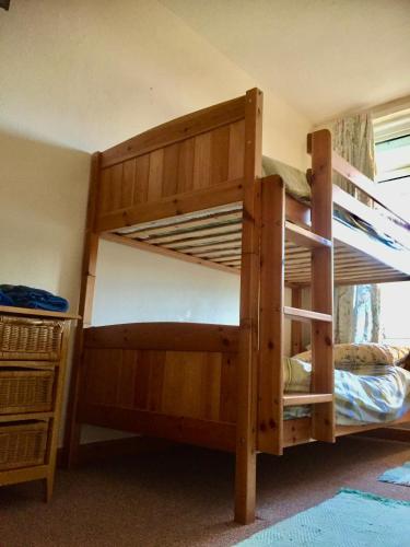 a bunk bed in a room with a bunk bedutenewayewayangering at Rustic Apartment with Sea Views in Freshwater East