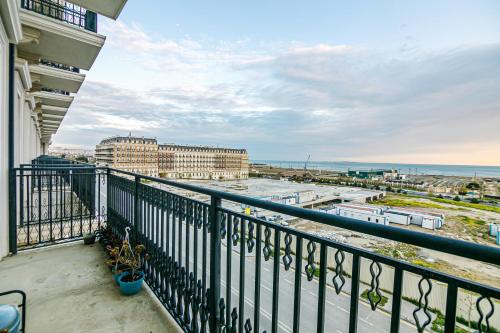 a balcony with a view of the ocean and buildings at Knightsbridge Apartment by Baku Housing in Baku