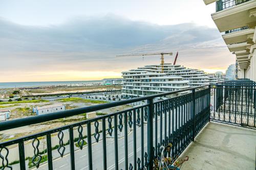 a balcony with a view of a cruise ship at Knightsbridge Apartment by Baku Housing in Baku