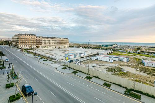 an aerial view of a highway with buildings and the ocean at Knightsbridge Apartment by Baku Housing in Baku