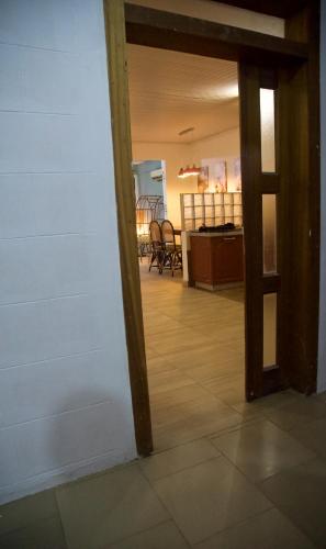 an open door to a kitchen with chairs in a room at Atlantic View Apartment in Takoradi