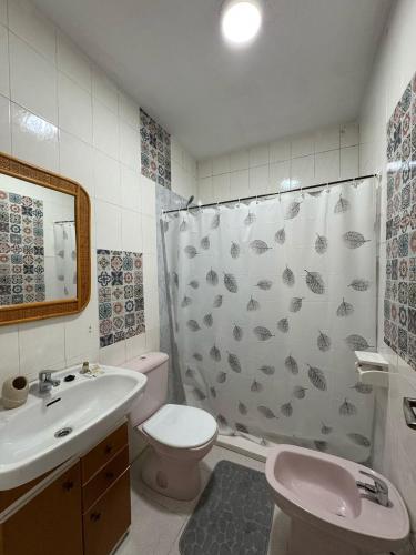 a bathroom with a sink toilet and a shower curtain at Mabel in San Javier