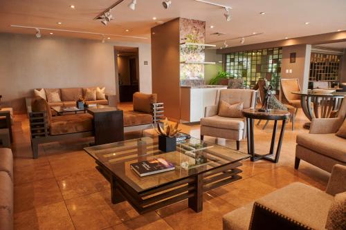 a living room with couches and a table at Casa Andina Premium Golf Los Incas in Lima