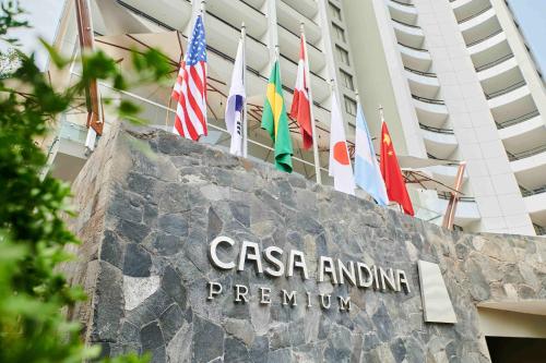 a sign in front of a building with flags at Casa Andina Premium Golf Los Incas in Lima