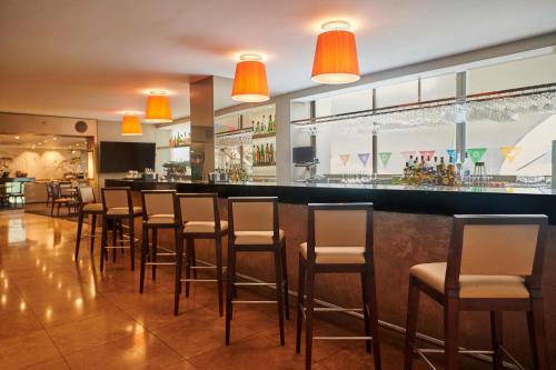 a bar in a restaurant with brown stools at Casa Andina Premium Golf Los Incas in Lima