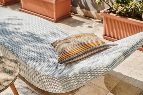 a wicker chair with a pillow sitting on a table at Casa Andina Premium Golf Los Incas in Lima
