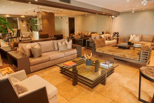 a large living room with couches and tables at Casa Andina Premium Golf Los Incas in Lima