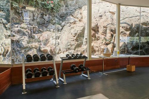 a room with a rock wall with a bunch of weights at Casa Andina Premium Golf Los Incas in Lima