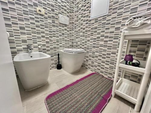 a bathroom with a sink and a toilet in a room at Abruzzi Home in Cologno Monzese