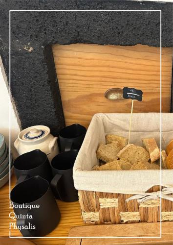 a basket of food sitting on top of a table at Boutique Quinta Physalis in Fenais da Luz