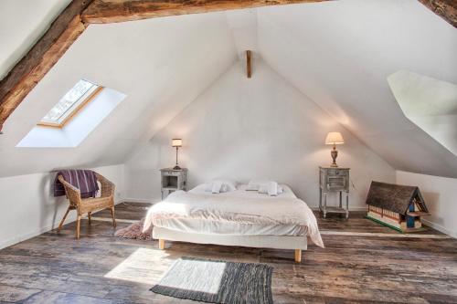 a bedroom with a bed in a attic at Belle demeure - Centre Ville - Jardin Botanique in Cabourg