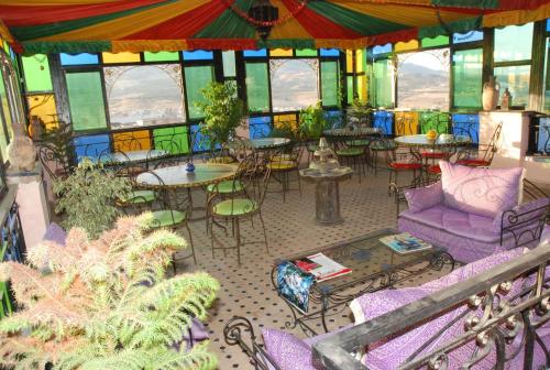 a room with tables and chairs in a building at Riad Khouloud in Fès