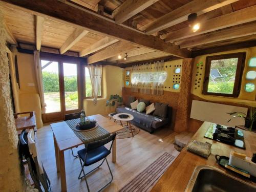 a living room with a couch and a table at Organic and artistic home in Payrignac