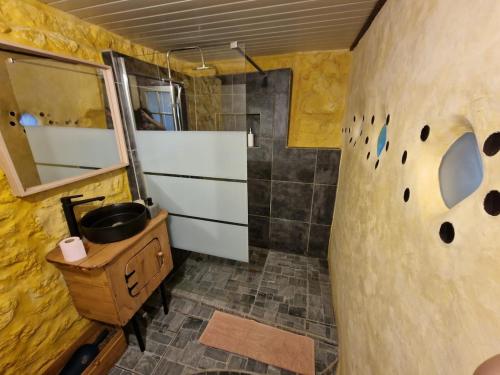 a bathroom with a sink and a shower at Organic and artistic home in Payrignac