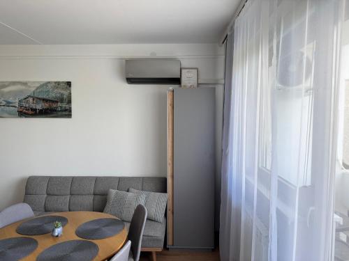 a living room with a table and a couch at Mini Premium in Miskolc