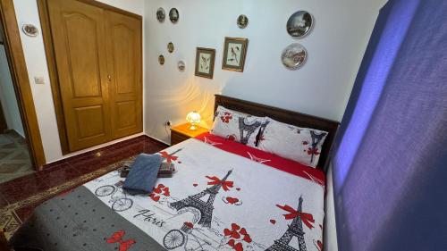 a bedroom with a bed with a comforter with the eiffel tower at شقة الفن Art Apartment in Marrakech