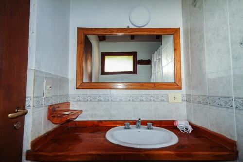 a bathroom with a sink and a mirror at Mont Blanc Bungalows in San Carlos de Bariloche