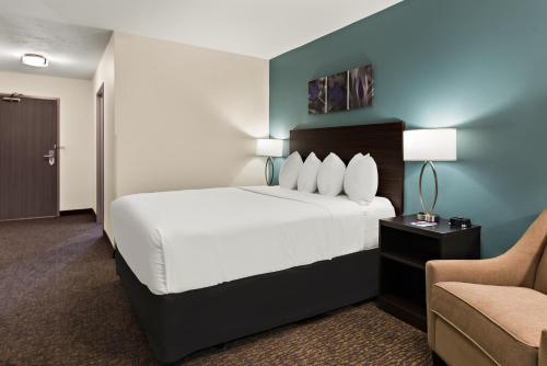 a hotel room with a bed and a chair at Sleep Inn Kelso Longview in Kelso