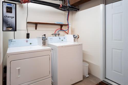 a laundry room with a washer and dryer at Jennifer's Riverfront Loft Apartment Historic Building in Providence