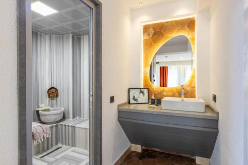 a bathroom with a sink and a mirror at BAB - by Menar Hotel in Istanbul
