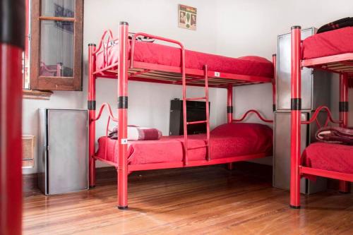 two bunk beds in a room with red furniture at Play Hostel Soho in Buenos Aires