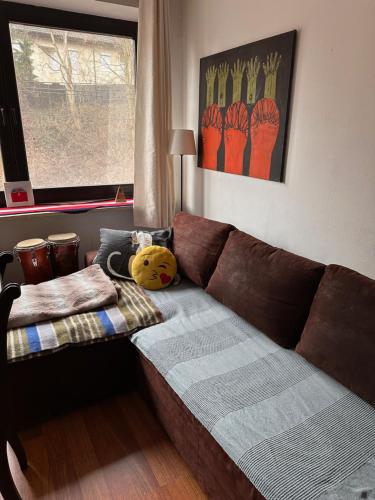 a living room with a brown couch and a window at Villatopol in Rząska